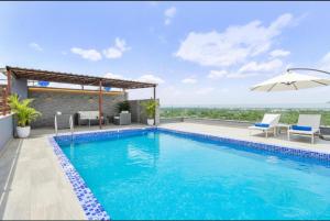 a swimming pool on the roof of a house at MANGAL RESIDENCY Mountain View- A Luxury Boutique Business Hotel in Bedla