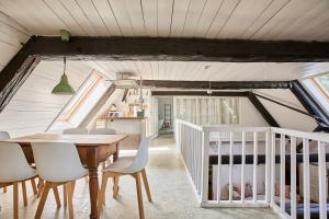 a dining room with a table and chairs and a crib at Altes Fährhaus - Ferienwohnung Boven, 220 qm in Wewelsfleth +20 photos