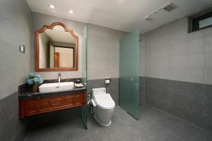 a bathroom with a toilet and a sink and a mirror at Sơn Nữ Emerald Hill Hotel in Bak Kan +26 photos