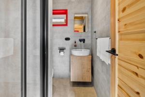 a small bathroom with a sink and a shower at Chalet na vrchoch in Nesluša +46 photos