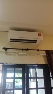 a air conditioner on the ceiling of a room with windows at hotel mutiara KGM in Malacca