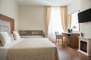 a hotel room with a bed and a desk at Albergo Rossini 1936 - Small & Charming in Bologna