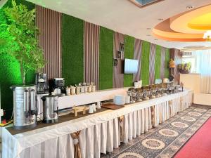 a restaurant with a long counter with a row of coffee makers at Khyber Hotel in Kabul