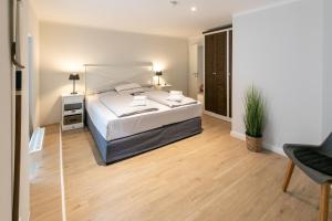 a bedroom with a bed and a desk and a chair at Dockside Travemünde in Travemünde