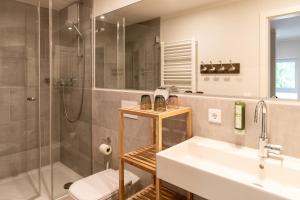 a bathroom with a sink and a shower and a toilet at Dockside Travemünde in Travemünde +290 photos