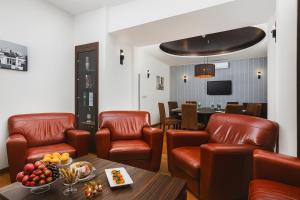 a waiting room with leather chairs and a table at Hotel Bratislava in Bratislava