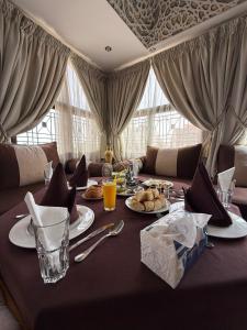 a table with food and drinks on top of it at Tiznit Hotel in Tiznit