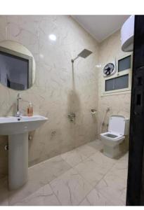 a bathroom with a sink and a toilet at Falcon pyramids inn in Cairo