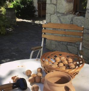 a basket of nuts sitting on a table next to a chair at Úrágya Vendégház in Mád +14 photos