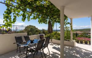 a patio with a table and chairs on a balcony at Villa Aristea Crikvenica by Villas Guide in Škrljevo