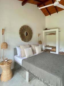 a bedroom with a large bed and a mirror at Kanferri Villa in Ahangama