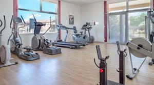 a gym with several exercise bikes and elliptical machines at Maison Les Demeures du Ventoux in Aubignan