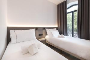 En eller flere senge i et værelse på NC Apartments Rambla 32