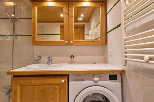 尚帕尼恩瓦努瓦茲Pralioud – Confort moderne, spa & piscine的配有洗衣机和水槽的浴室