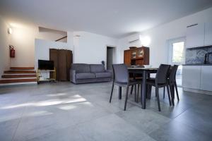 a kitchen and dining room with a table and chairs at Max in Condofuri