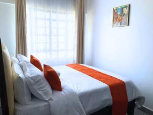 Postel nebo postele na pokoji v ubytování Inka Residency Kisumu