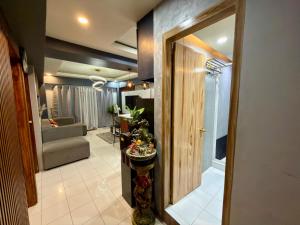 a hallway with a living room with a door and a couch at Baguio Transient Across Burnham Park 2 - 2BR Condo in Baguio +34 photos