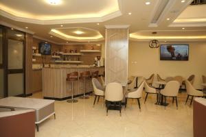 a restaurant with a table and chairs and a bar at Yofel Hotel Bole in Addis Ababa