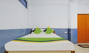 a bedroom with a bed with green and blue walls at Itsy Hotels Shillong Tower Guesthouse in Shillong +38 photos