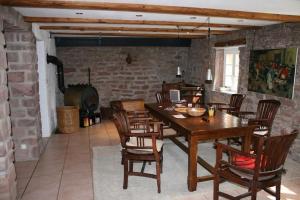 ein Esszimmer mit Tisch und Stühlen und einem Kamin in der Unterkunft Ferienhaus In Walscheid Mit Terrasse, Grill in Walscheid + 32 Fotos