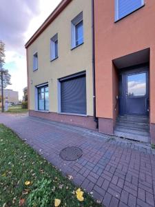 a house with two garage doors on the side of it at Louis Apartaments in Skorka