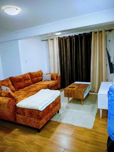 a living room with a couch and a coffee table at Cosmic home in Thika +5 photos