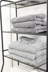 Ein Stapel Handtücher auf einem Handtuchhalter in der Unterkunft Elegant 2BR Escape in Manhattan with WiFi & Parking in Manhattan