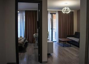 een kamer met een woonkamer met een bank en een bed bij Crystal Loft Bakuriani Apartment in Bakuriani