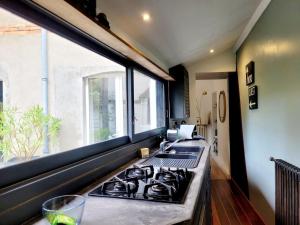 a kitchen with a gas stove and a window at La maison de jade - Demeure de charme avec parking in Nantes +47 photos