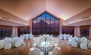 a banquet hall with white tables and white chairs at Amari Vang Vieng in Vang Vieng +176 photos