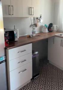 a kitchen with a counter top with a microwave at Ruralux Aroche in Aroche