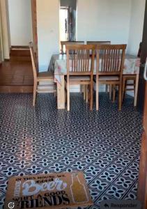 a dining room with a table and chairs on a patterned floor at Ruralux Aroche in Aroche