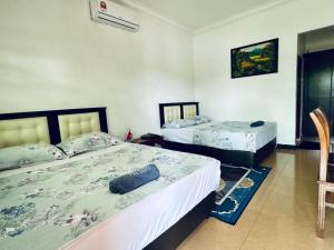Ένα ή περισσότερα κρεβάτια σε δωμάτιο στο Villa Desa Permai