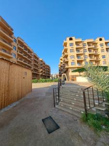 a set of stairs in front of some apartment buildings at Turtles beach resorts in Hurghada