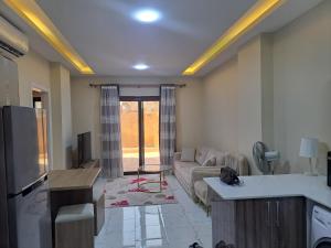 a living room with a couch and a tv at Turtles beach resorts in Hurghada