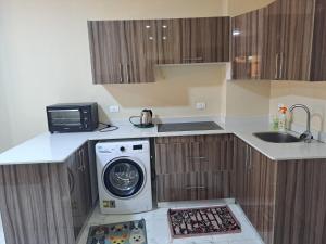a kitchen with a washing machine and a sink at Turtles beach resorts in Hurghada