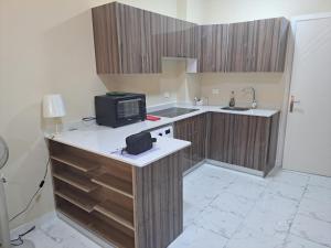 a small kitchen with a microwave on a counter at Turtles beach resorts in Hurghada +2 photos