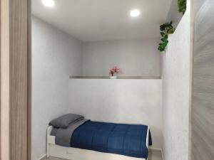 a bedroom with a bed with a blue blanket at Al civico 14 in Foggia