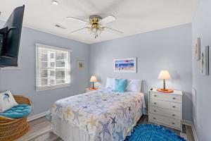 a bedroom with a bed and a ceiling fan at Oceanfront 3BR with Stunning Views, Private Balcony and Pool in Myrtle Beach +48 photos