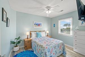 a bedroom with a bed and a ceiling fan at Oceanfront 3BR with Stunning Views, Private Balcony and Pool in Myrtle Beach