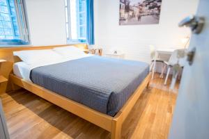 a bedroom with a bed and a table and a desk at Hydra's Ruby in Hydra