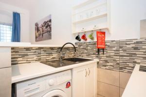 a kitchen with a sink and a dishwasher at Hydra's Ruby in Hydra