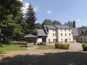 a large white building with a park in front of it at Wolfsgrund in Sayda
