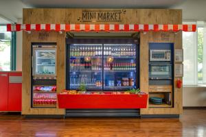 a drink market with a red counter in a store at ibis Berlin Messe in Berlin