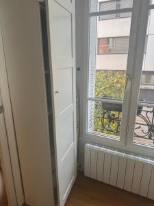 a room with a window and a radiator at Cute appartement in Boulogne-Billancourt