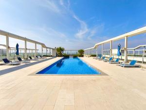 a swimming pool on the roof of a building at Azure Sands 2BR Escape with Priavte Beach and Pool in Al Marjan Island in Ras al Khaimah