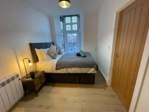 a bedroom with a large bed and a window at The Old Town Hall - Flat 4 in Grove