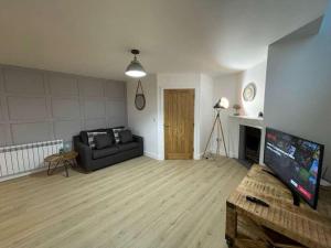 a living room with a couch and a flat screen tv at The Old Town Hall - Flat 4 in Grove +14 photos