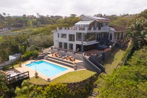 an aerial view of a house with a swimming pool at Beachcomber Bay Guest House In South Africa in Margate