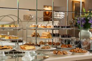 a buffet with different types of pastries and desserts at Albergo Rossini 1936 - Small & Charming in Bologna